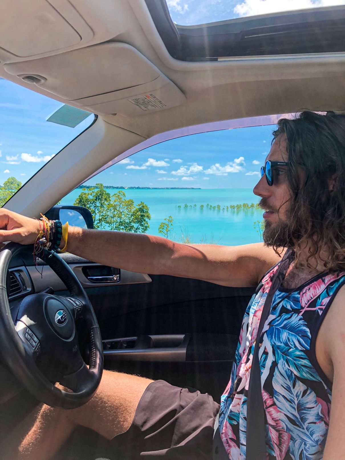 me driving a car in Tarawa with the lagoon 