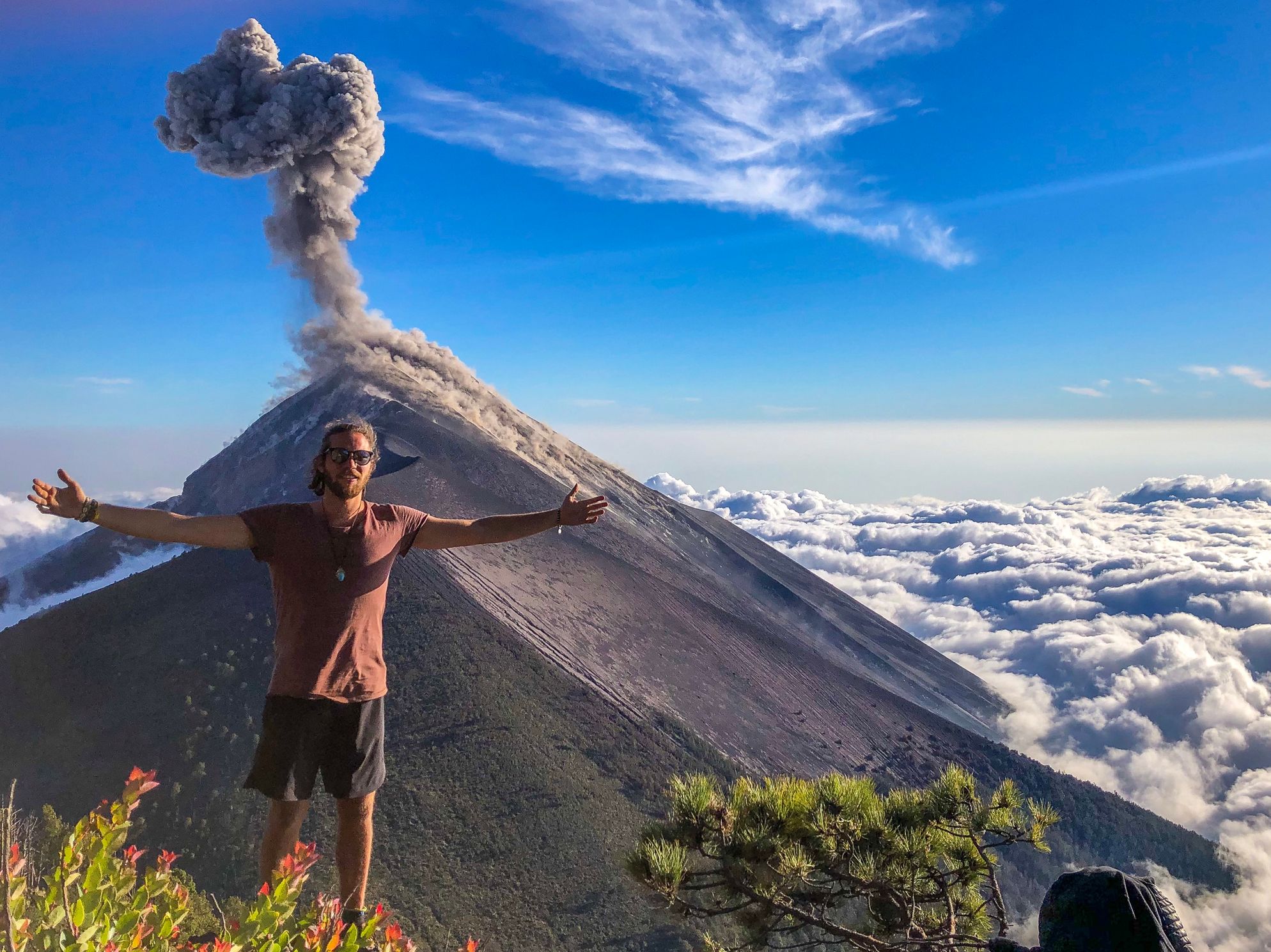 me in front af an active volcano above the clouds