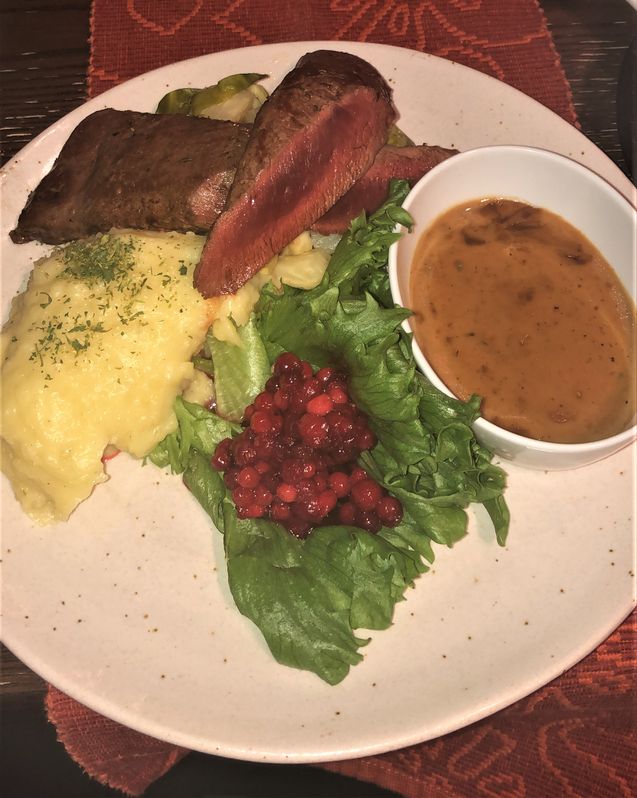 great meal in Svalbard with reindeer meat, berries, salad and potatoes