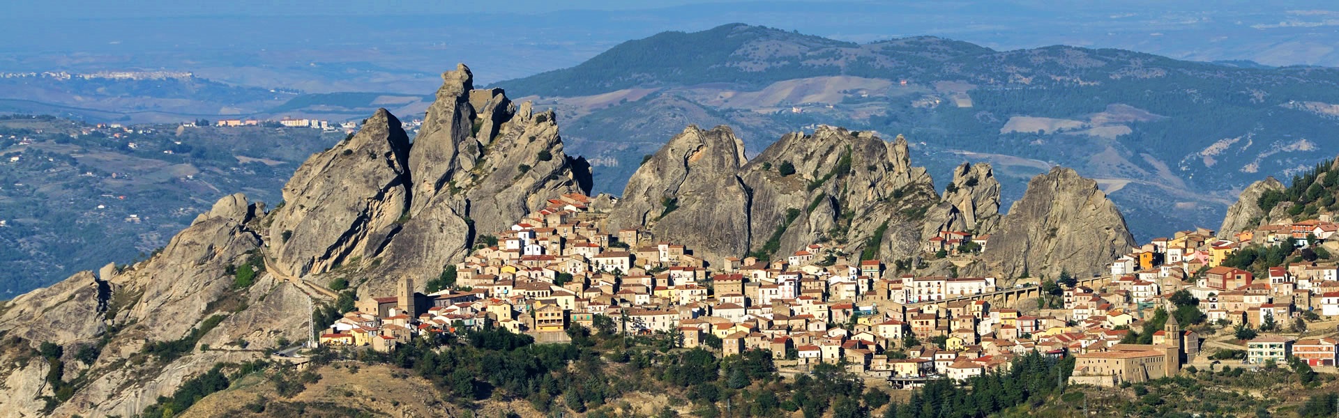 The Lucanian dolomites with rocky peaks and a village underneath